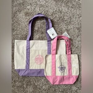 1 large lavender and 1 mini pink trader joe’s tote